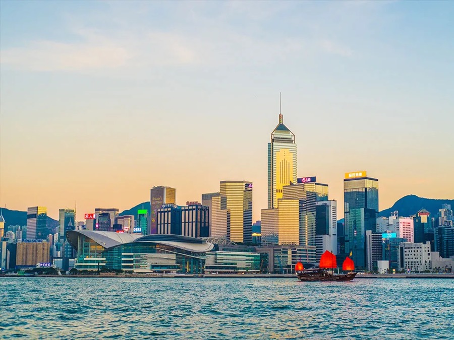 Victoria Harbour skyline with a red-sailed junk boat